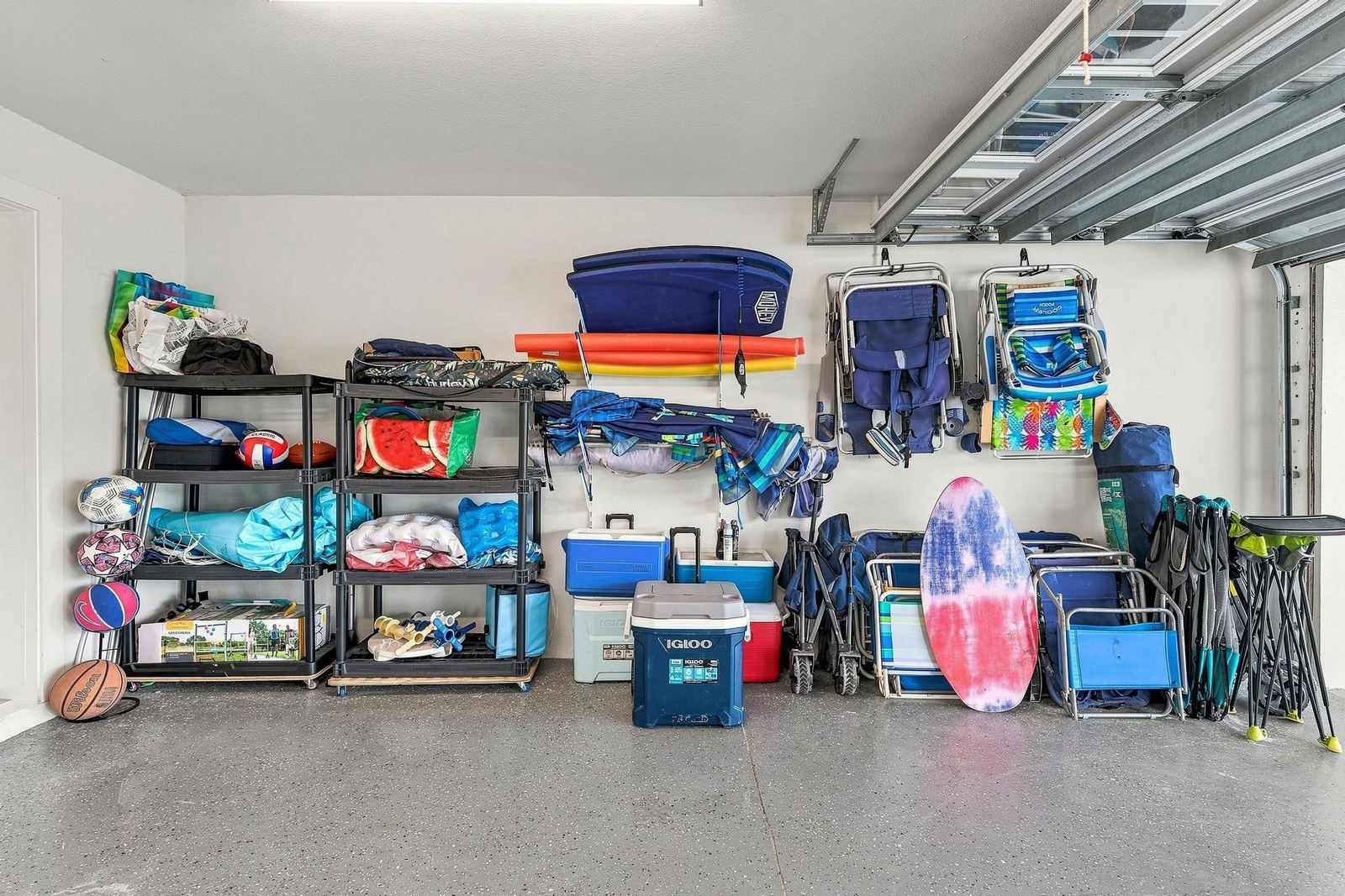 Garage stocked with beach chairs, boogie boards and coolers