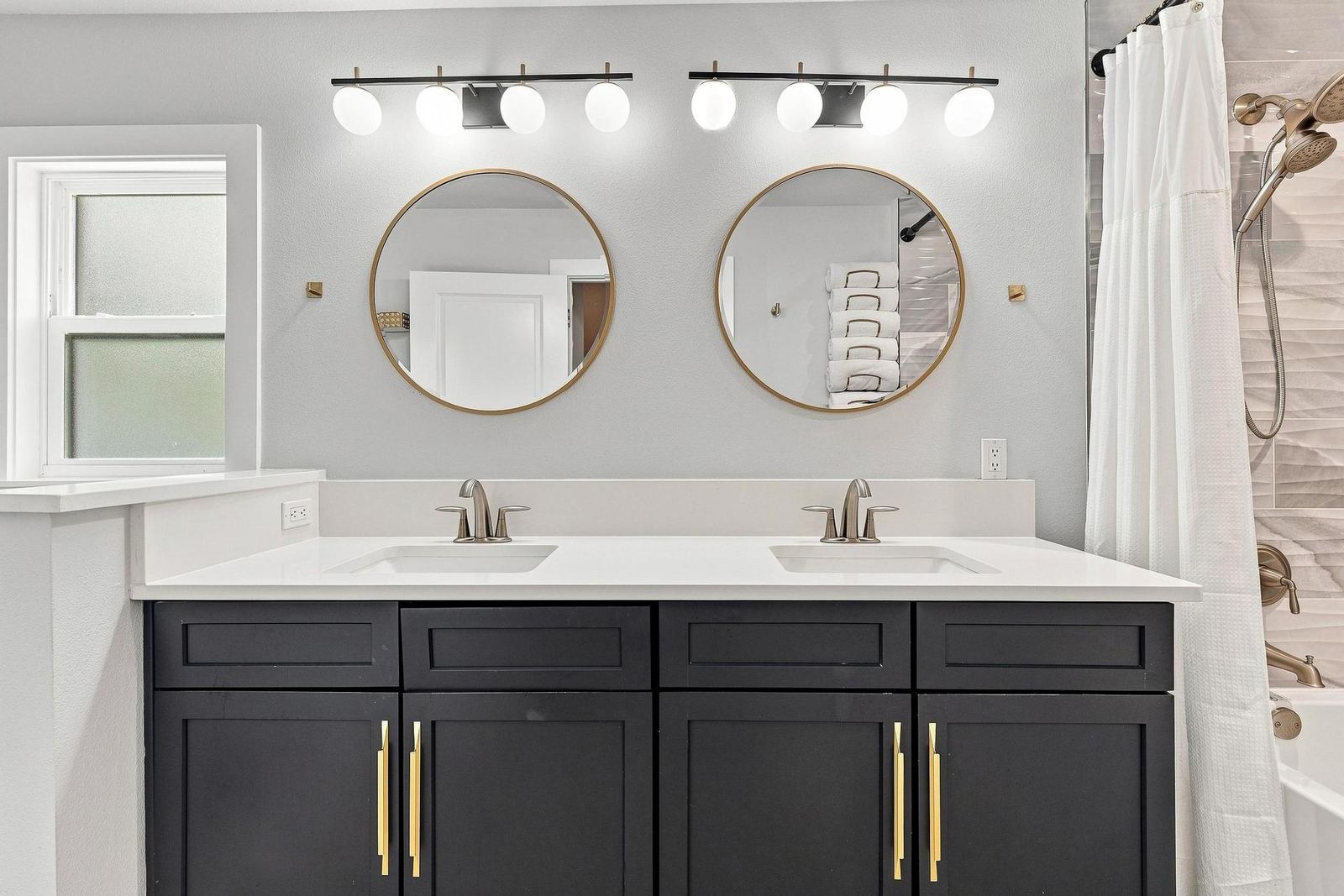 Bathroom with double vanity and round mirrors