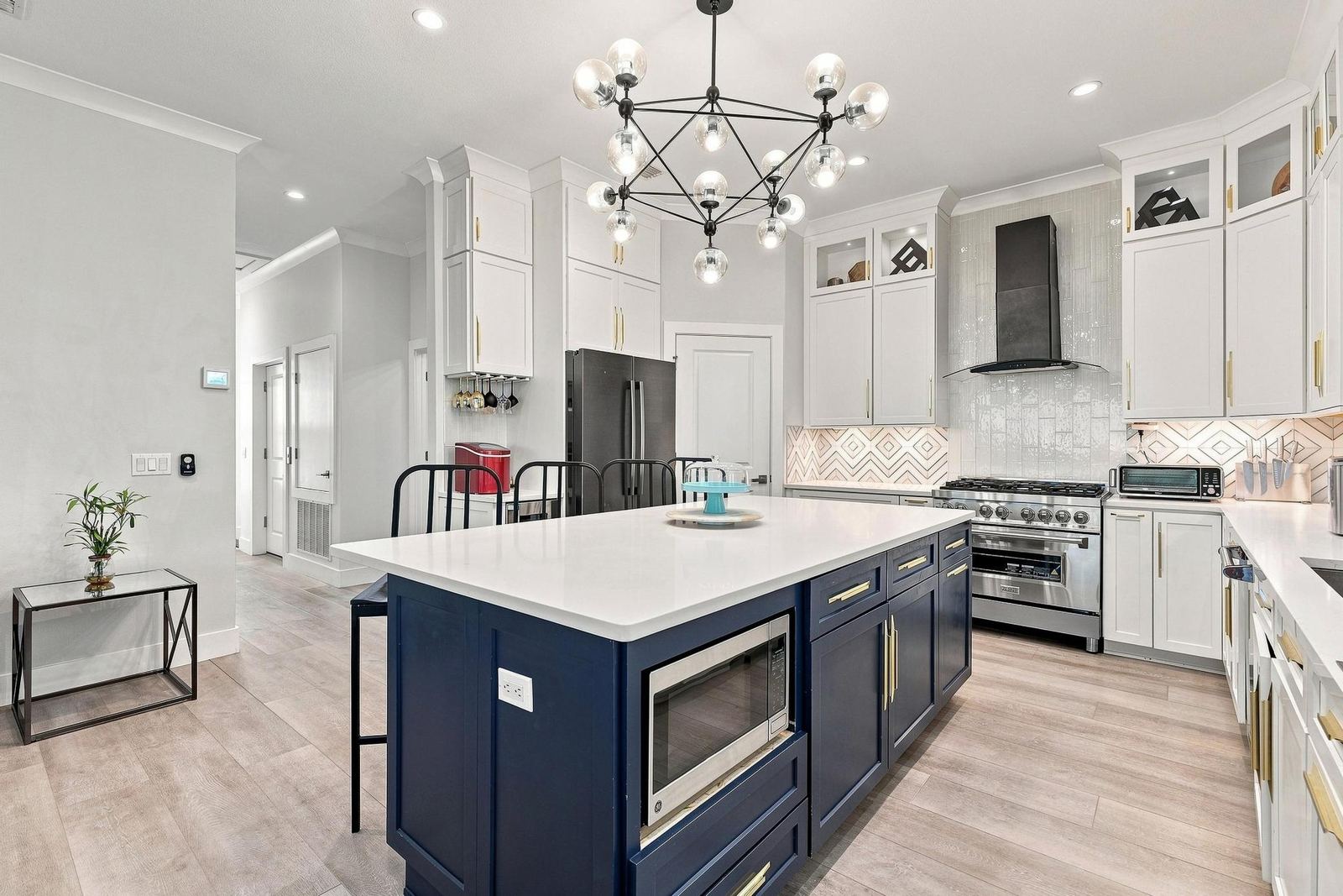 Kitchen with navy island and gold hardware