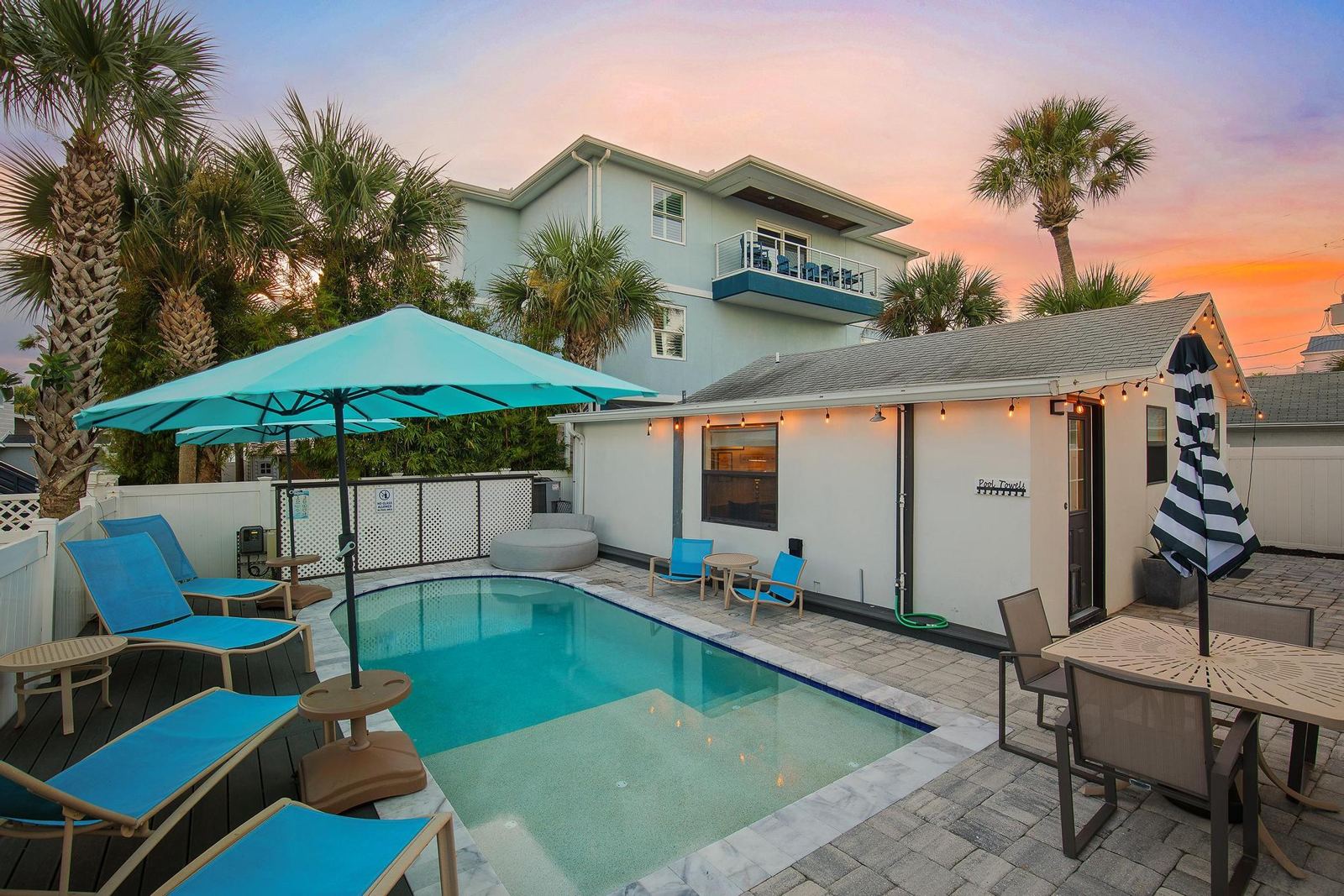 Saltwater pool and guest house at dusk