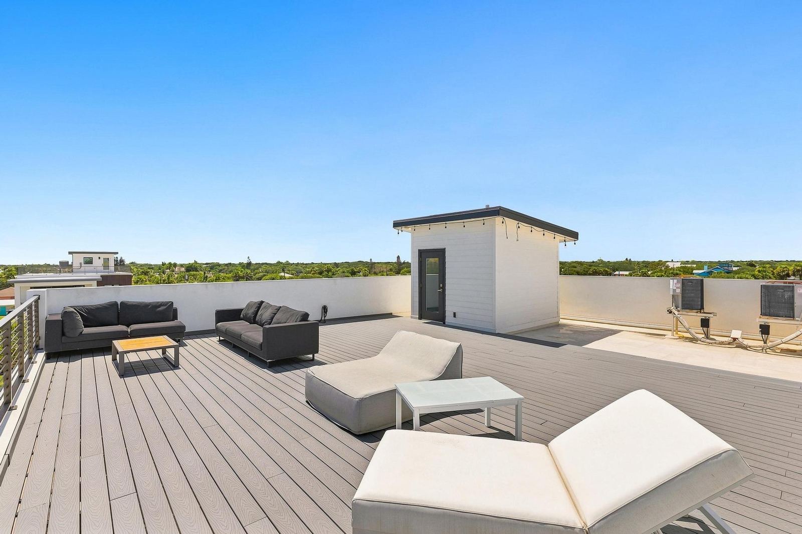 White loungers on the rooftop deck